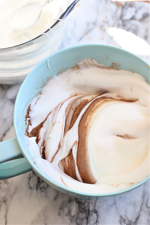 Folding the beaten egg whites into the chocolate mocha mixture.