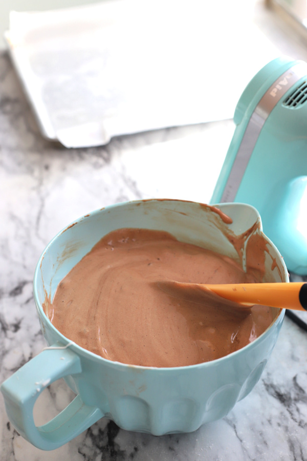 Folding the beaten egg whites into the chocolate mocha mixture.