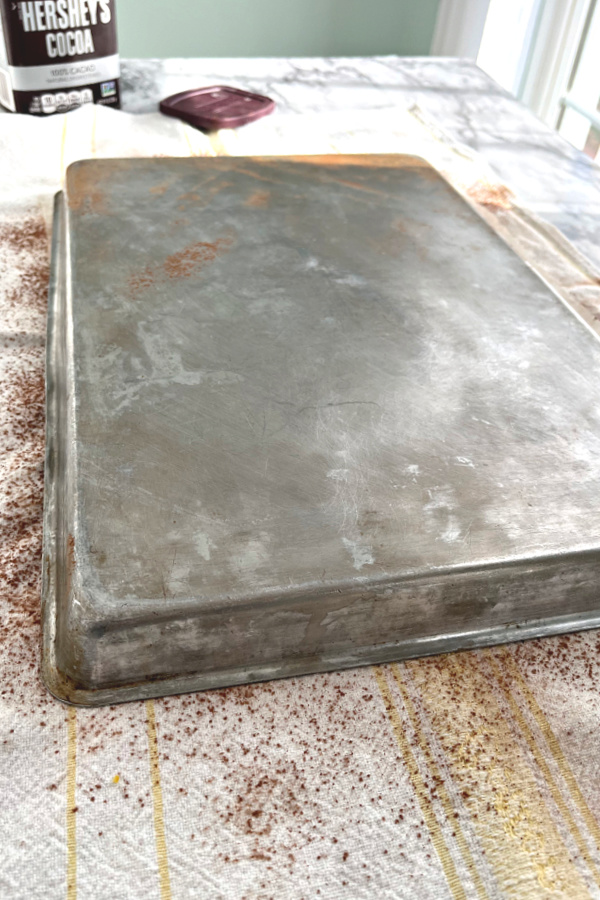 Removing baked sponge cake from jelly roll pan.