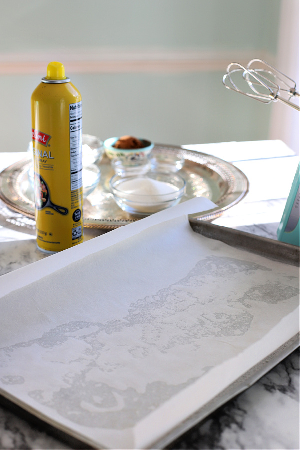 Parchment lines a jelly roll pan for mocha Yule Log.