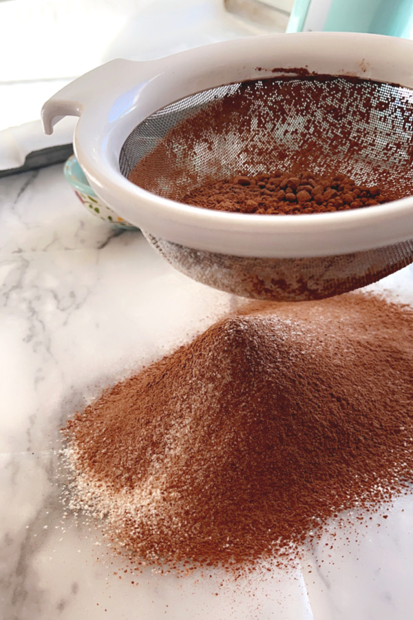 Sifting the flour and cocoa powder for a Yule Log cake.