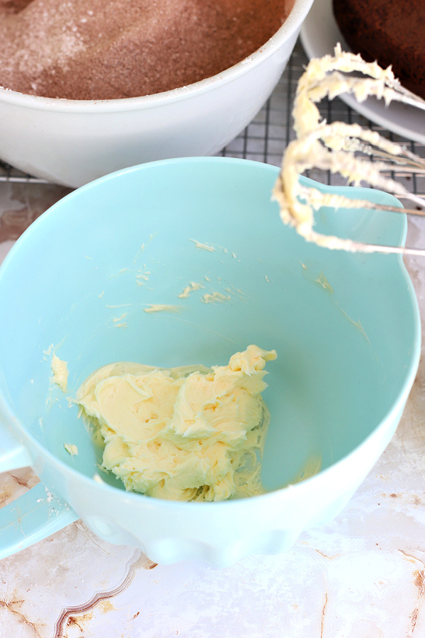 Creaming the butter for fluffy chocolate frosting.