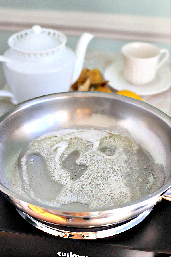 Heating the butter in a skillet for making sautéed bananas.