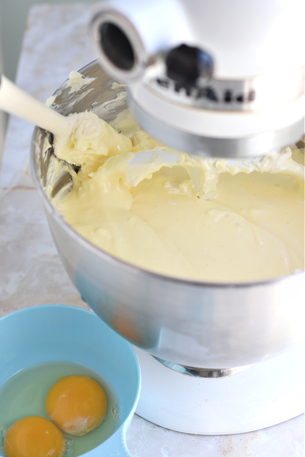 Scraping down the bowl while making the cream cheese filling for NY style cheesecake recipe.