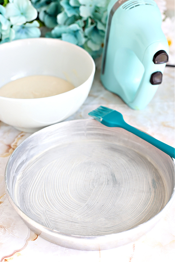 Spreading Goop homemade easy cake pan release for baking.