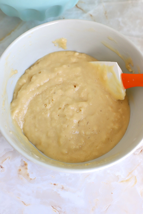 Gently stirring the wet and dry ingredients for basic muffins recipe.