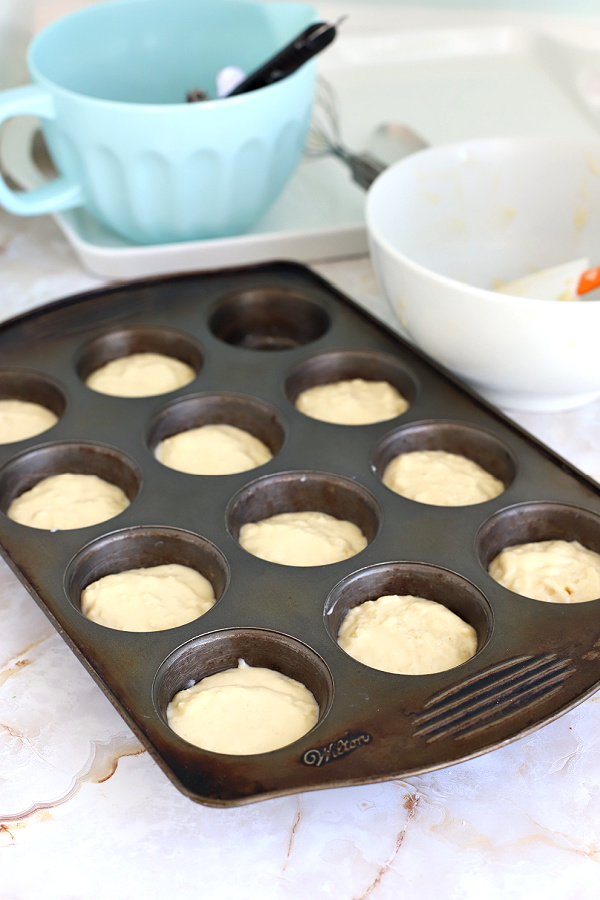 Pouring the batter into prepared pan for basic muffins recipe.