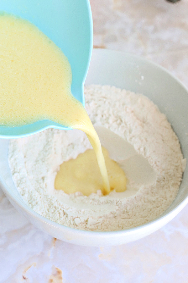 Adding the wet ingredients to the dry for basic muffins recipe.