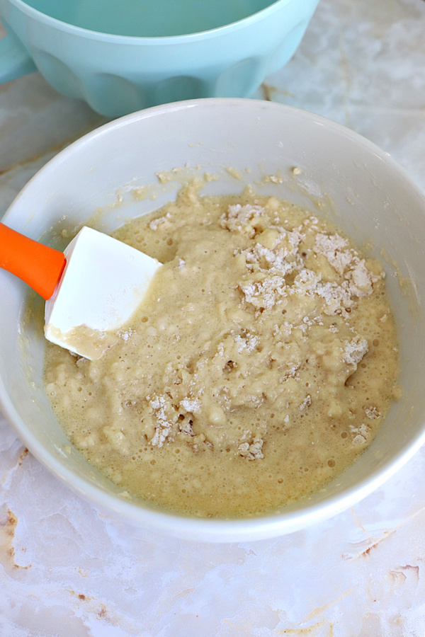 Gently stirring the wet and dry ingredients for basic muffins recipe.