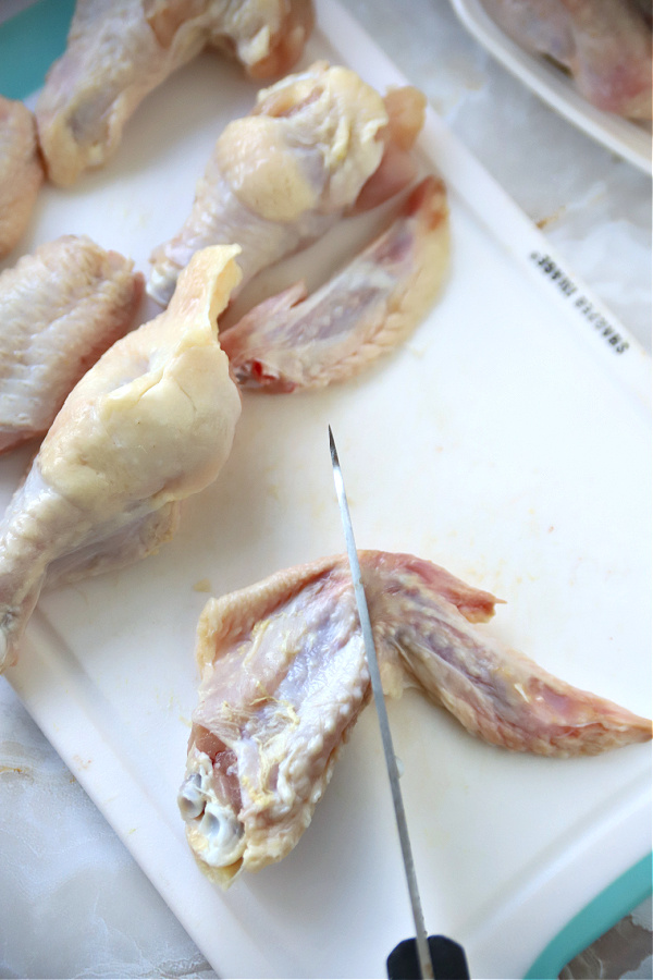 Cutting away the tips for making honey garlic chicken wings recipe.