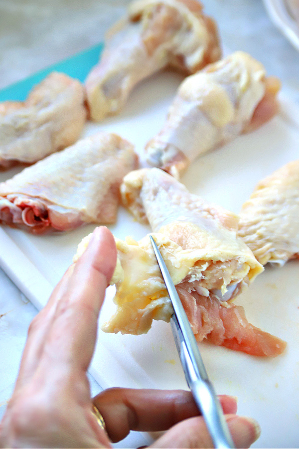 Trimming the parts of the wing for making honey garlic chicken wings recipe for appetizers.