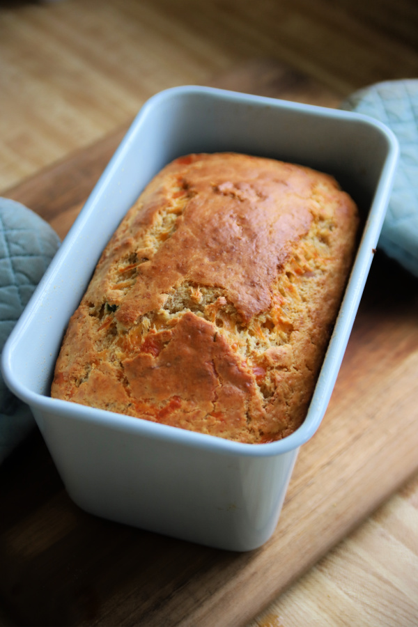 Fresh out of the oven cheese bacon and wheat germ quick bread loaf.