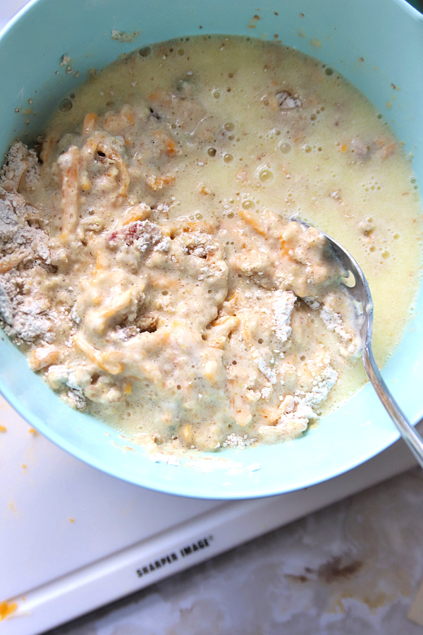 Stirring the batter for cheddar cheese bacon and wheat germ quick bread recipe.