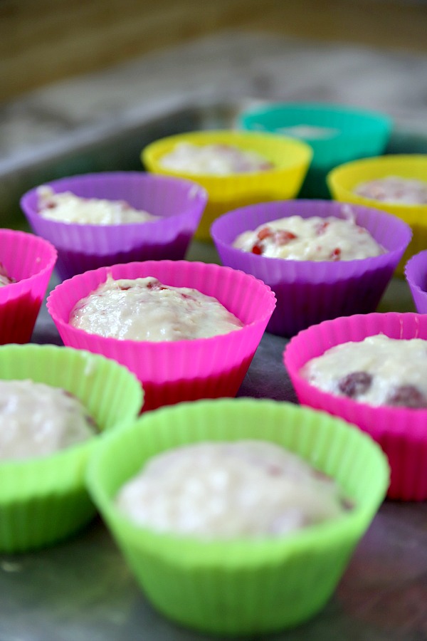 Filling tin with batter for raspberry very berry muffins recipe.