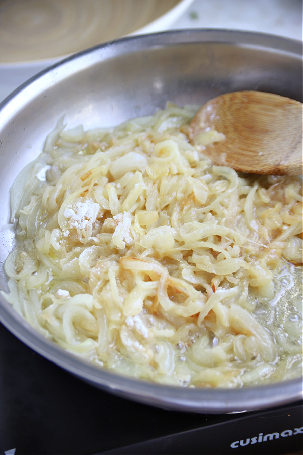 Caramelizing sliced onions and butter for English pub style bangers and mash with onion gravy recipe.