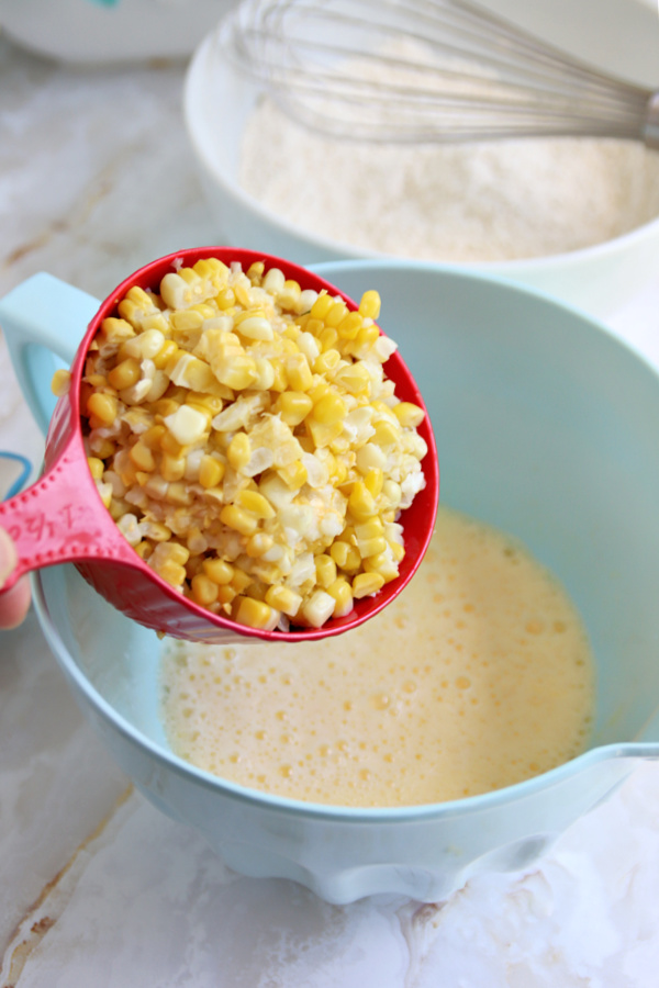 Adding fresh from the cob corn to the batter for corn fritter recipe.