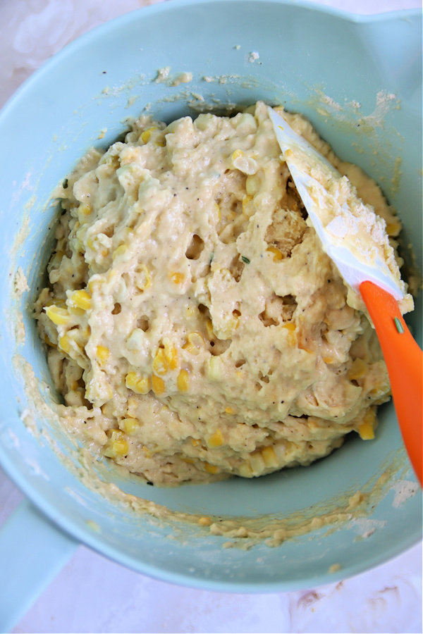 Stirring the dry and wet ingredients for easy corn fritter recipe.