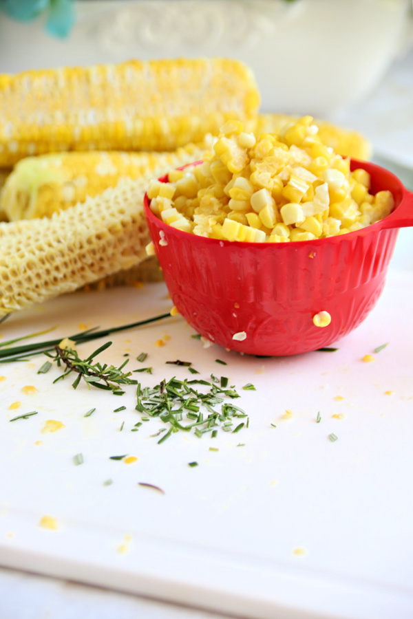 cutting fresh corn from the cob for corn fritters