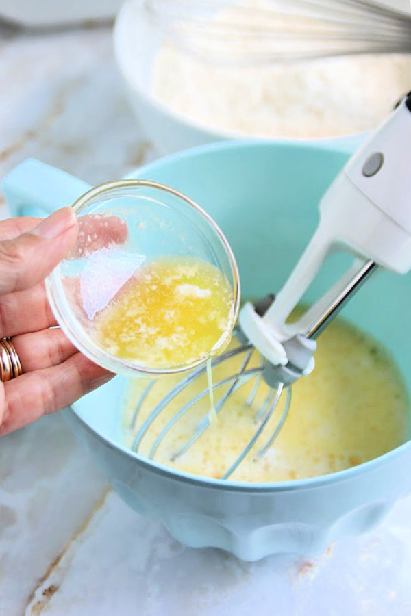 Adding eggs to the wet ingredients for easy corn fritter recipe.