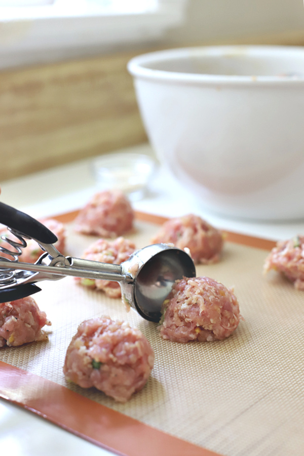 Scooping ground pork meatball mixture for bulgogi sauce tacos