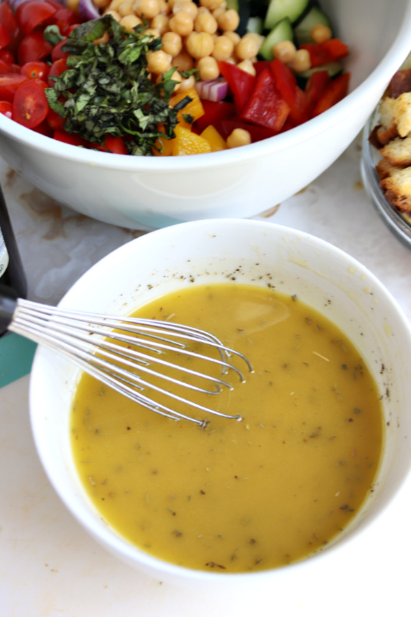 Making the dressing for Greek panzanella salad.