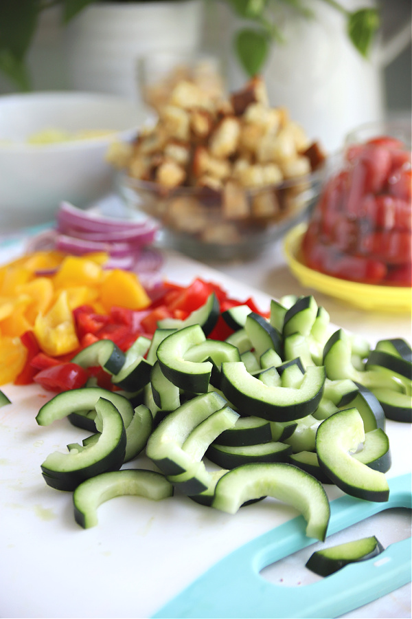 Prepping hothouse cucumbers for Greek Panzanella salad.