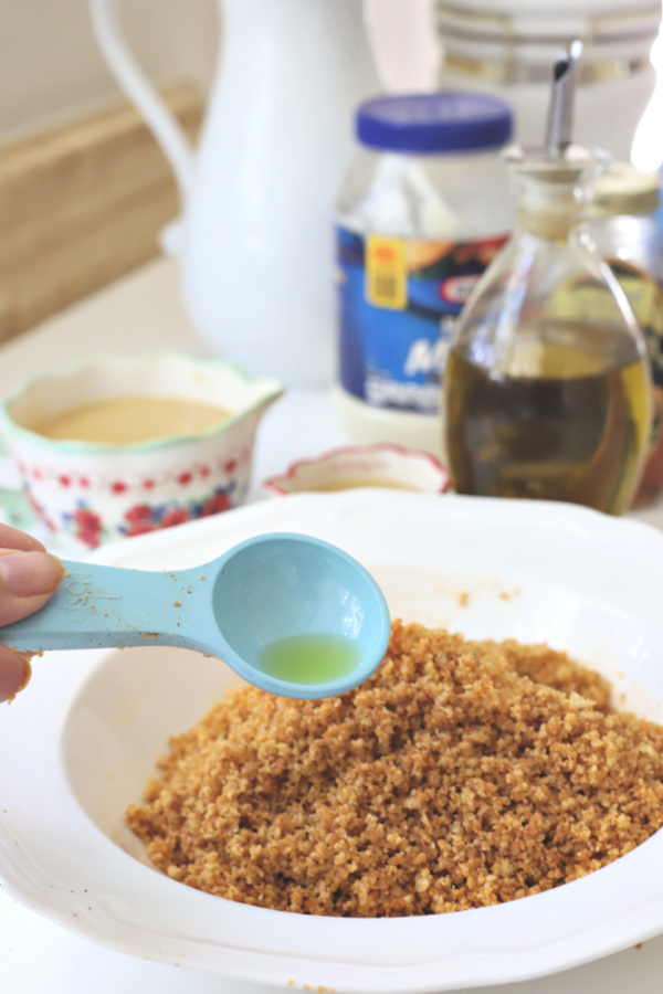 Easy recipe for juicy chicken breasts with a crispy Parmesan and panko coating. Oven baked rather than fried, Parmesan crusted chicken is drizzled with honey mustard sauce. 