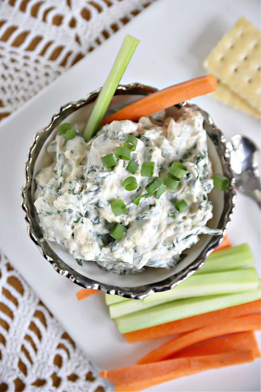 Serve this favorite spinach dip appetizer for a party charcuterie board. Easy recipe with crunchy water chestnuts and green onions.