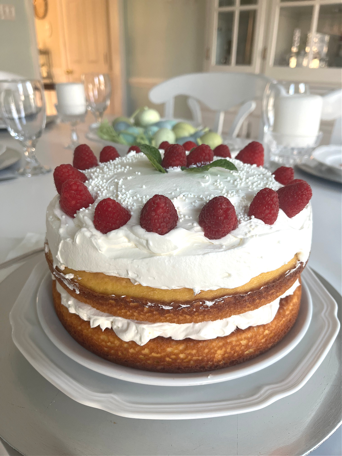 Easter Lemon cake dessert with stabilized whipped cream and raspberries