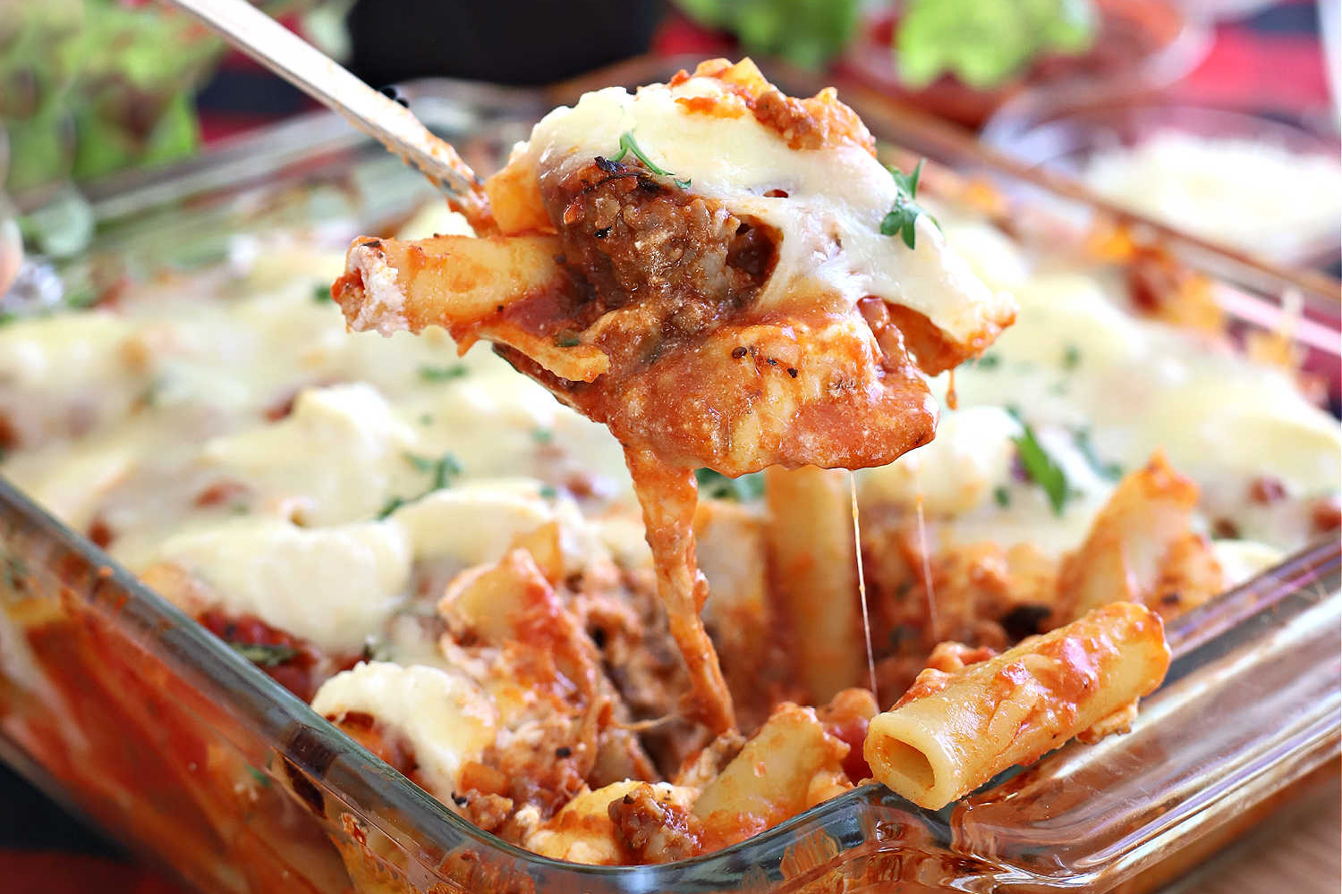 Cheesy baked ziti, a classis pasta casserole, with sausage or ground beef, tomato sauce, ricotta, mozzarella and parmesan is an easy recipe.